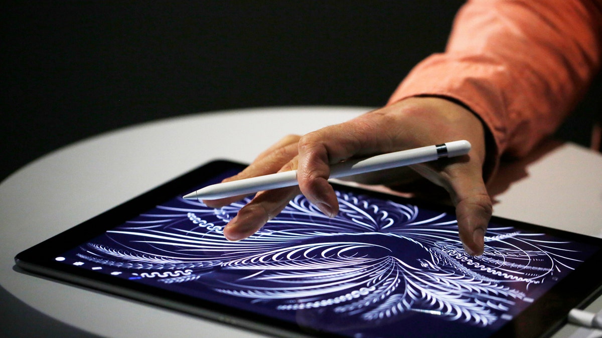 Person using Apple Pencil with an iPad